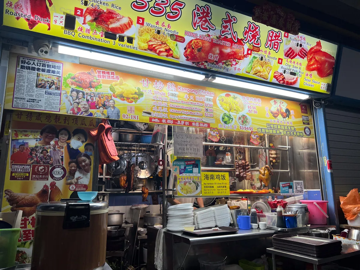 At a food stall in Tanjong Pagar, Outram, Central Region, Singapore, an array of cooked and grilled dishes is on display. Colourful signage shows a selection of dishes including roast duck, Hainanese chicken rice and BBQ combos. In the background hang kitchen items, with plates and bowls neatly stacked. A sign praises the stall as 'Singapore Best Foods' while images of happy customers are woven into the scene. The ambience feels busy and welcoming.